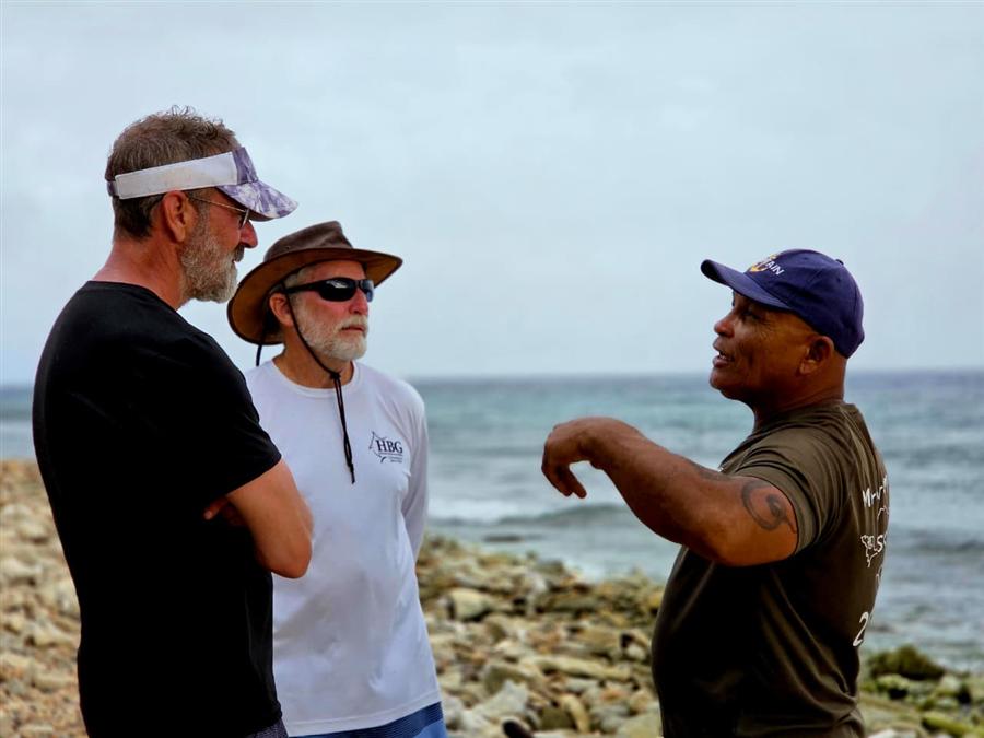 Rambo telling island stories to two guests on Sea Glass Island