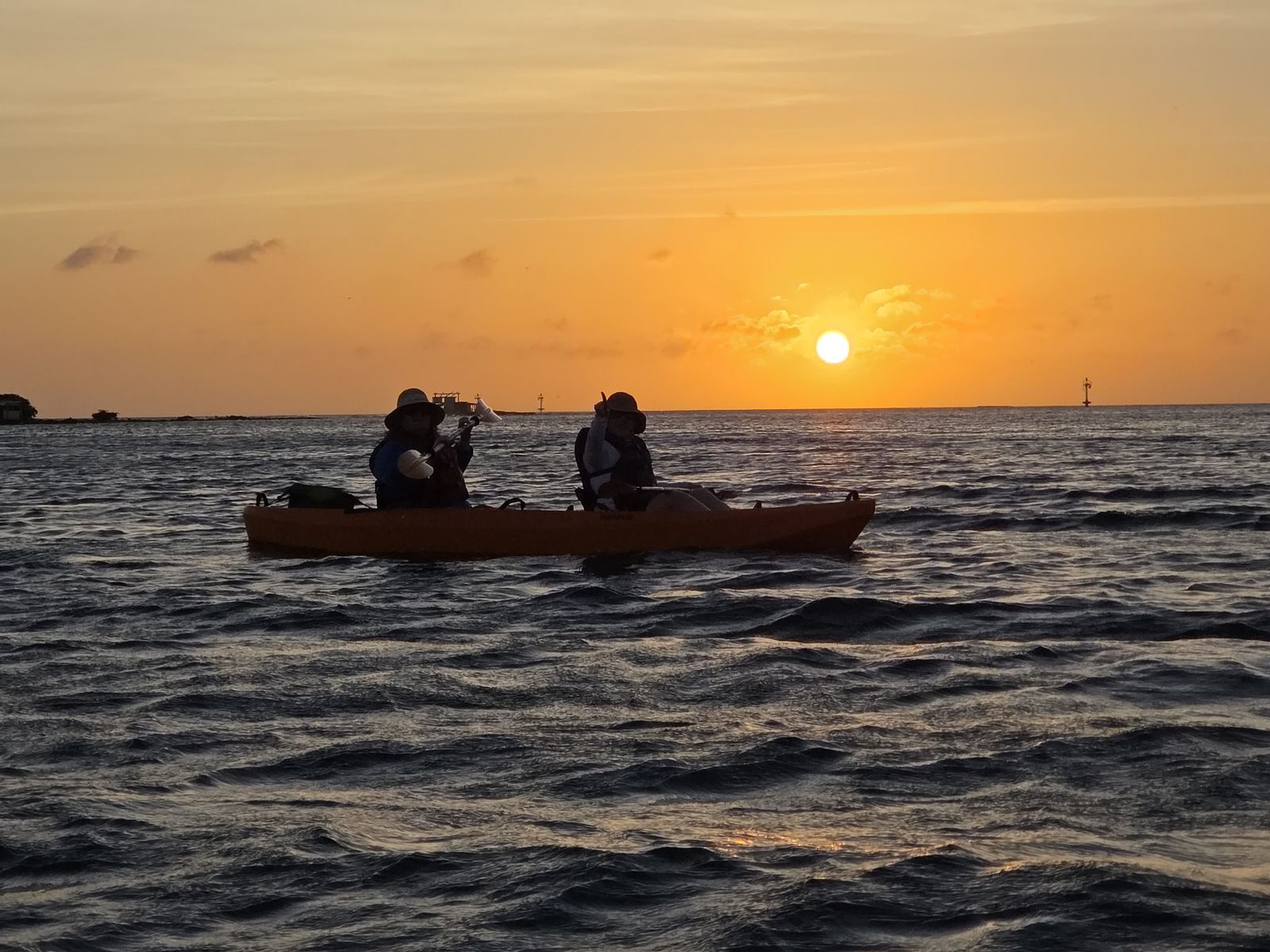 Sunset over the water off the Savaneta coast, seen from one of our kayaks