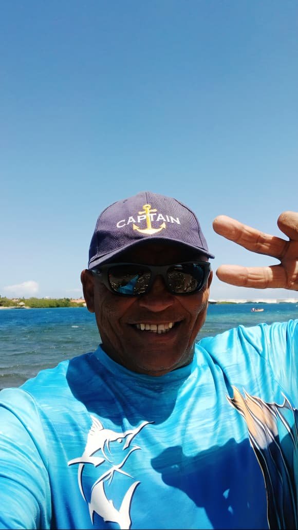 Rambo — your guide, smiling on the water in his captain's hat